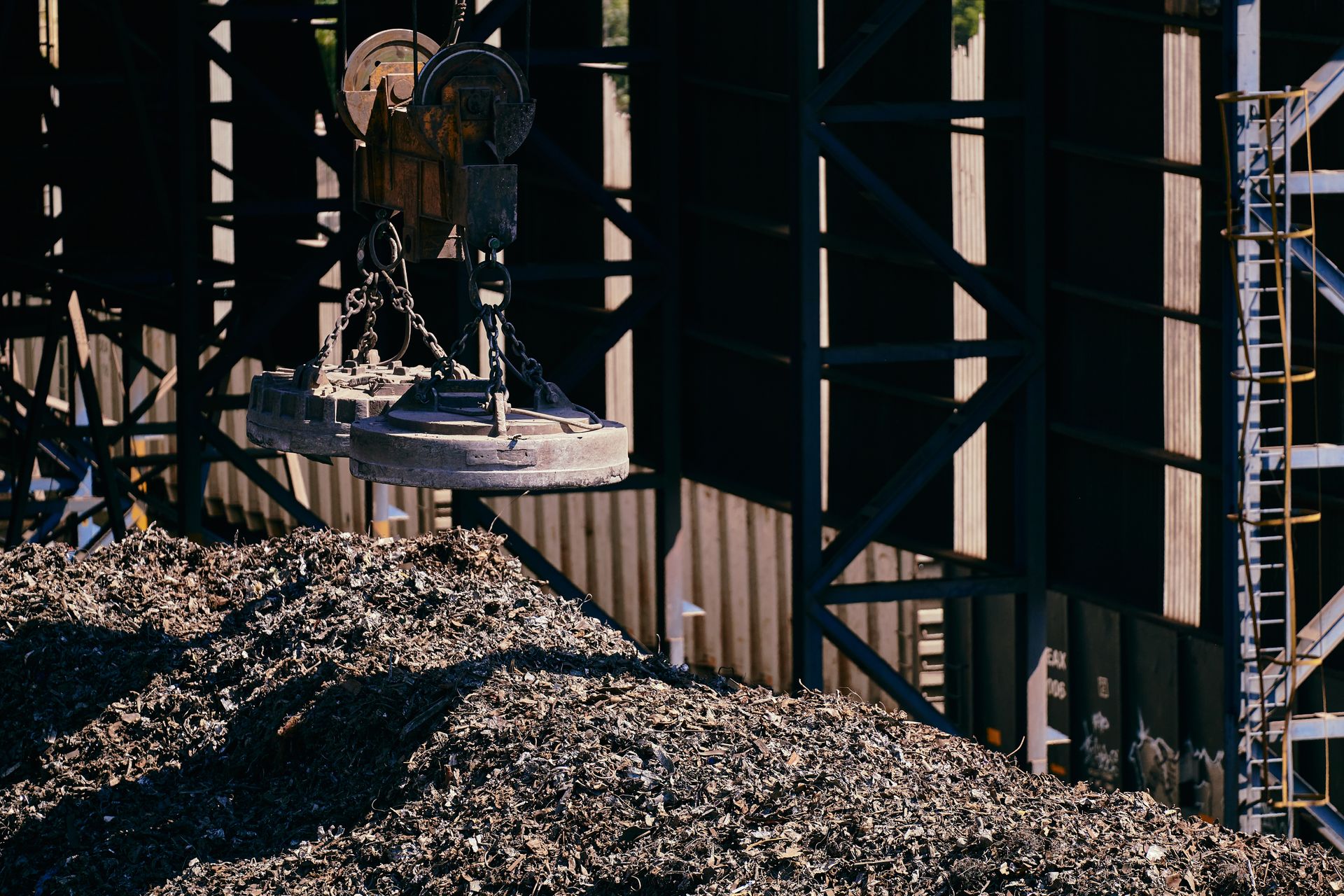 Industrial scrap metal being handled at a recycling yard